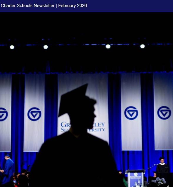 A student in graduation cap and gown standing during a commencement ceremony.